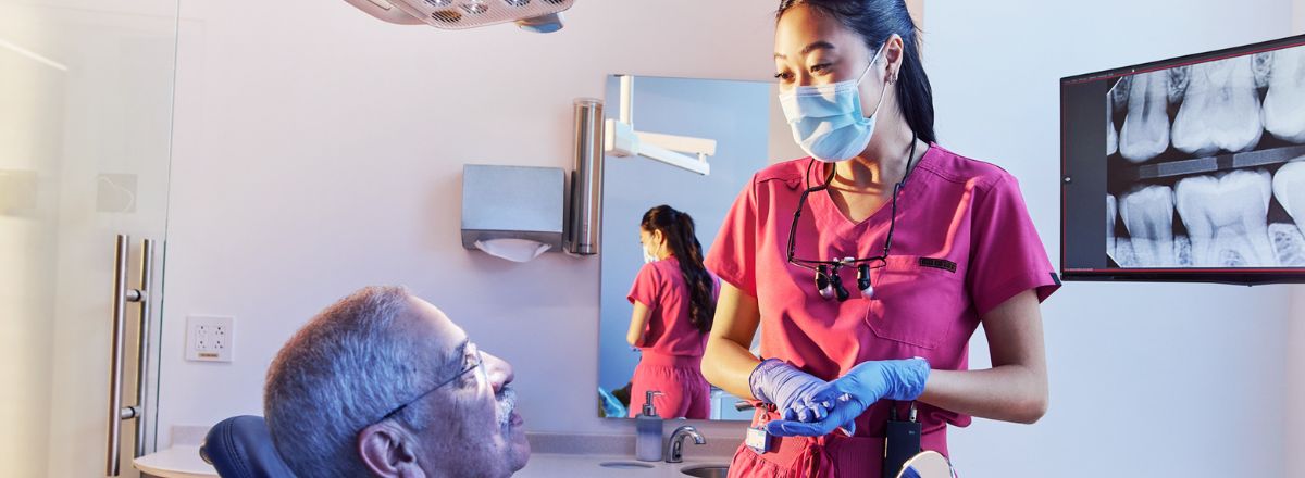 Two dentists talking over x-rays
